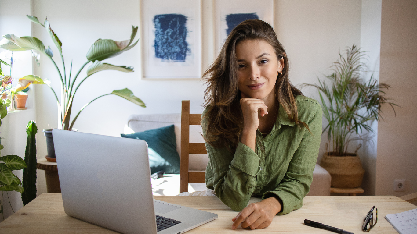 Professional woman sitting at a desk with a laptop, representing dedication, organization, and focus in personal injury case management.