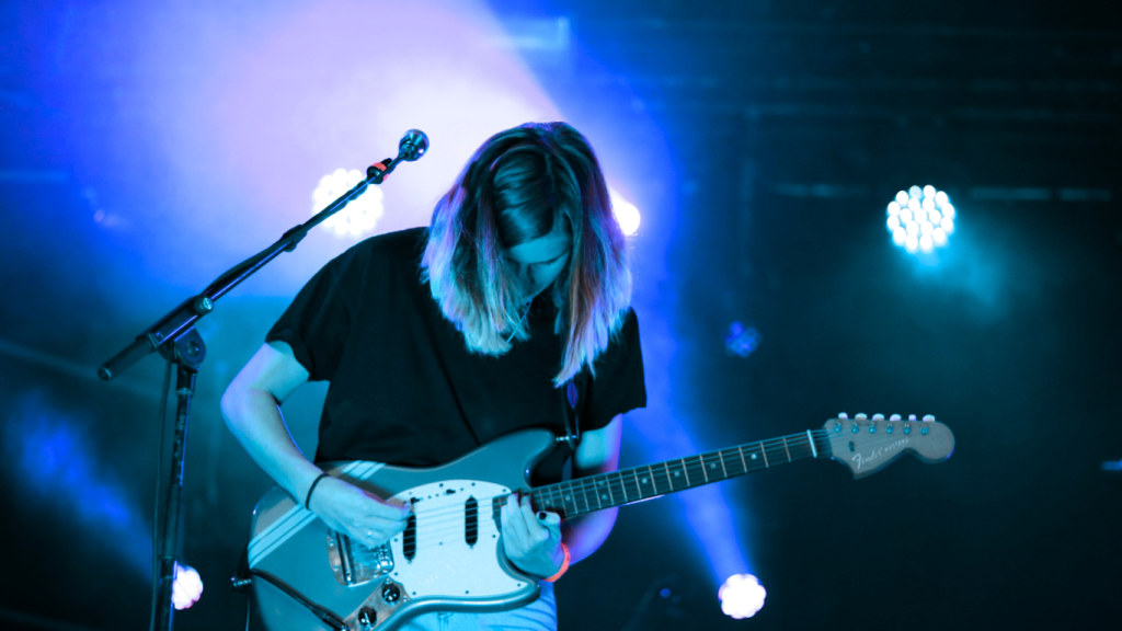 Case manager represented as a rockstar holding a blue electric guitar, symbolizing excellence, passion, and leadership in personal injury case management.