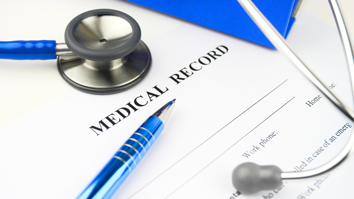 Stethoscope and pen resting on a medical record form illustrating the role of medical records in personal injury cases.